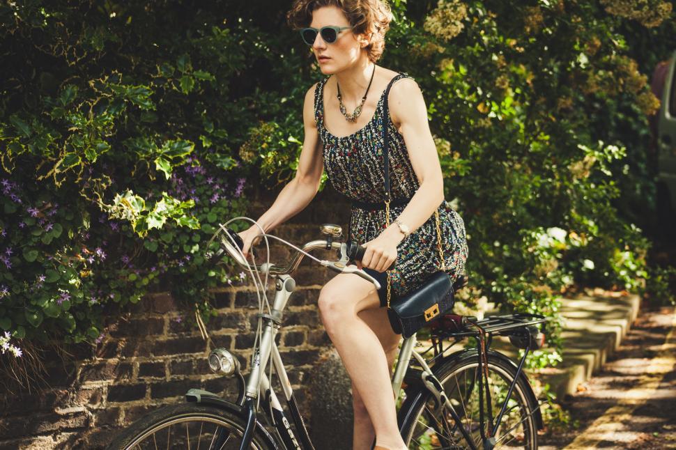 Free Image of Woman Riding a Bike Down a Street 