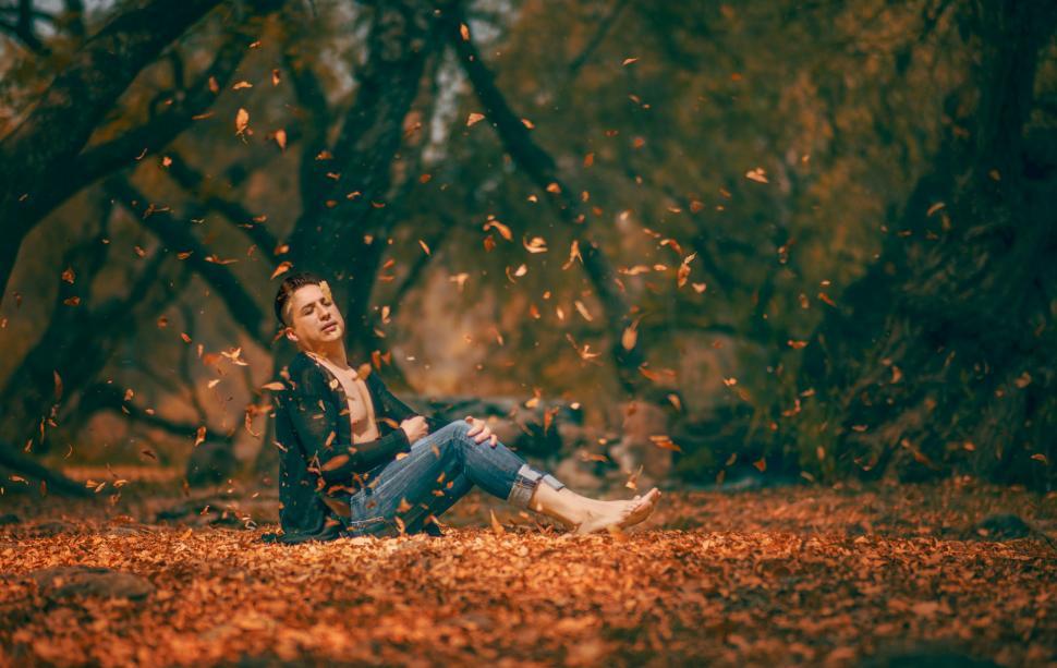 Free Image of Woman Sitting on Ground in Forest 