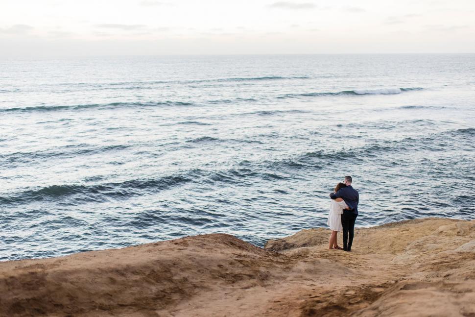 Free Image of Couple Enjoying View on Sandy Beach 