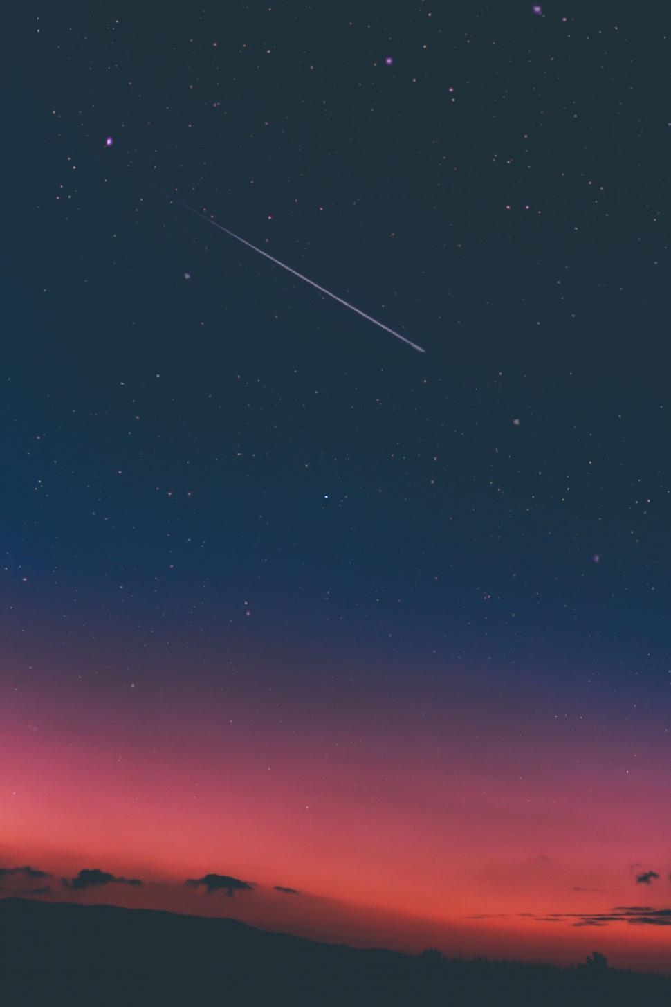 Free Image of Night Sky With Plane Flying in the Distance 