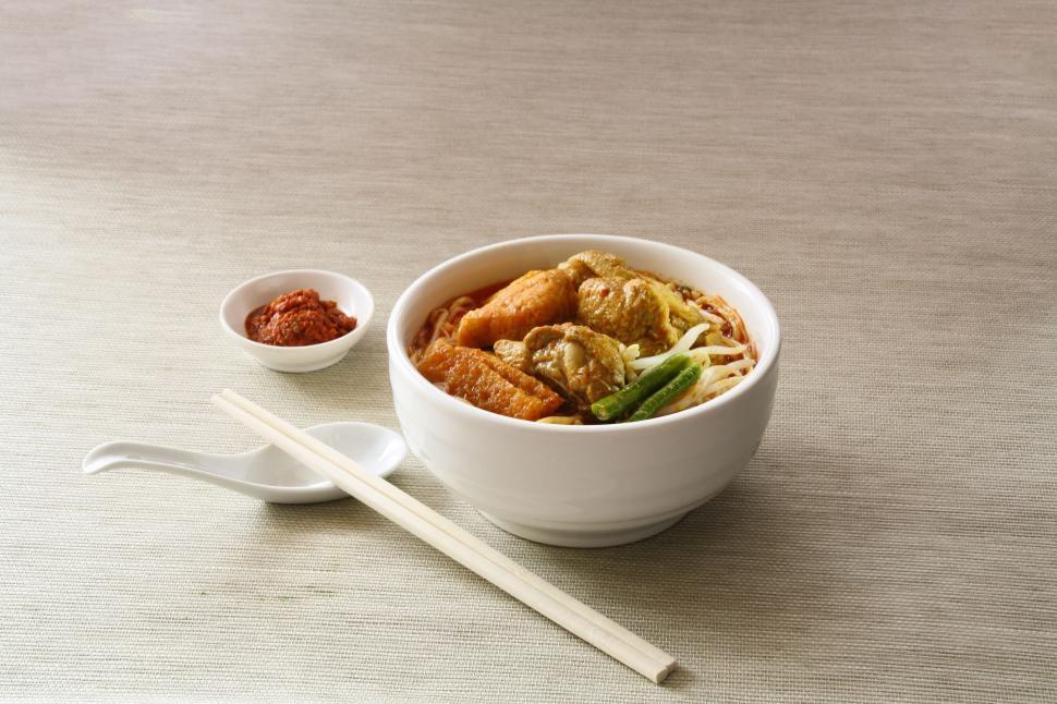 Free Image of A Bowl of Food With Chopsticks on a Table 