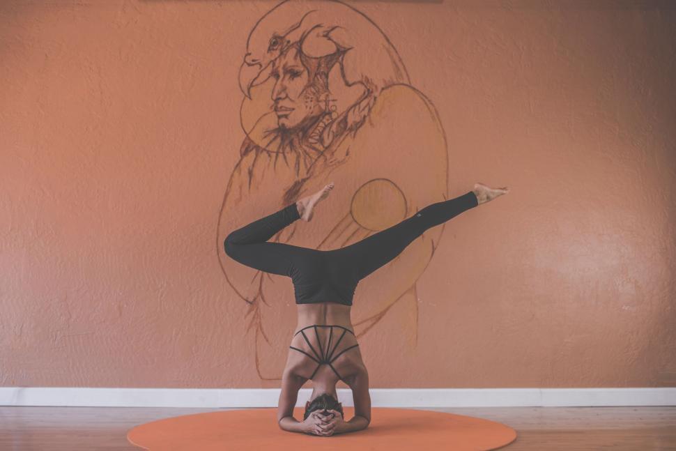 Free Image of Woman Performing Handstand in Front of Drawing 