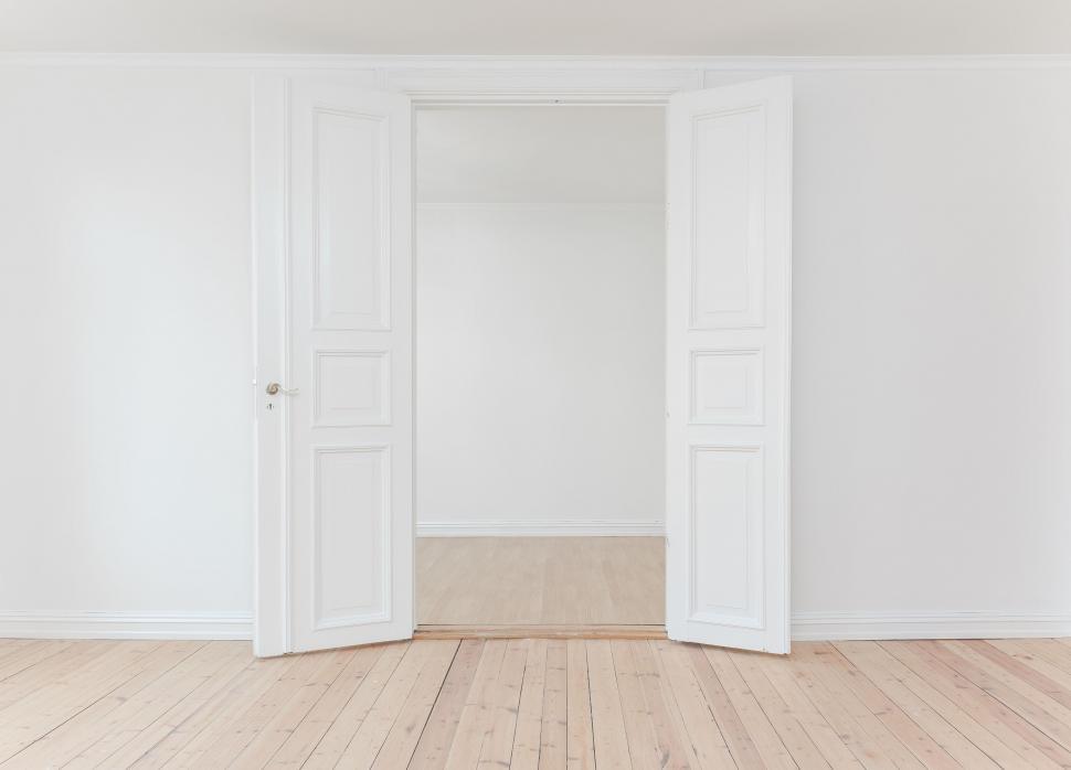Free Image of An Empty Room With Two Doors Open 