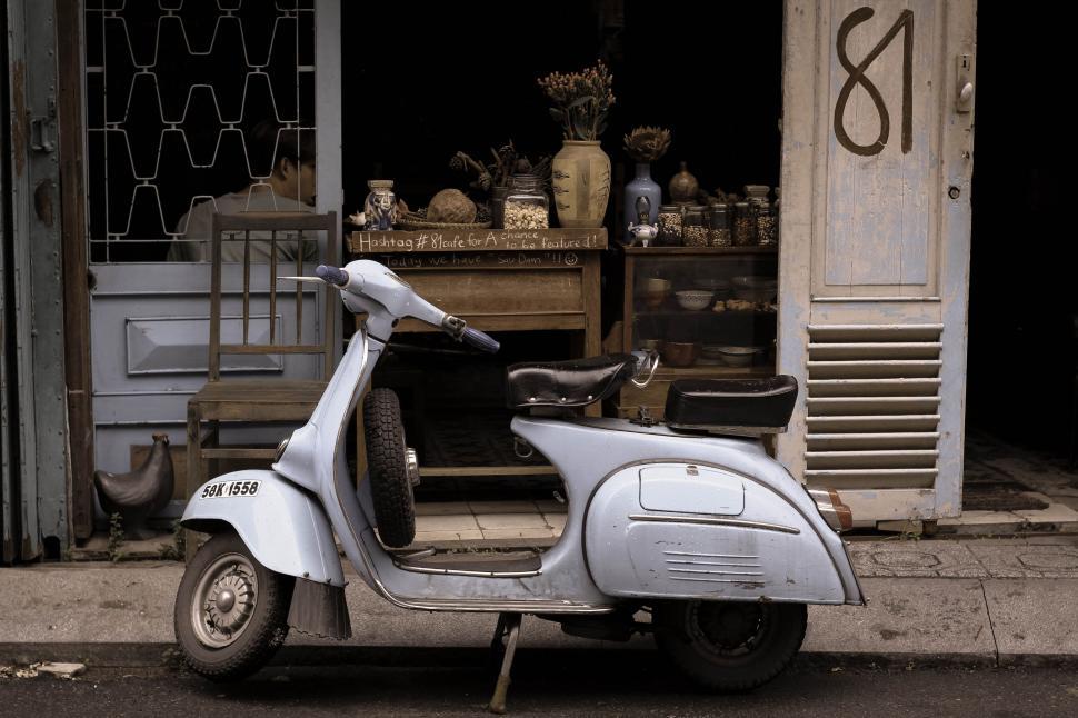 Free Image of Motor Scooter Parked in Front of Store 