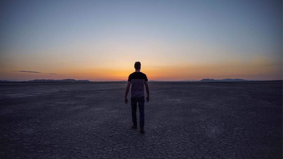 Free Image of Man Standing in Desert at Sunset 