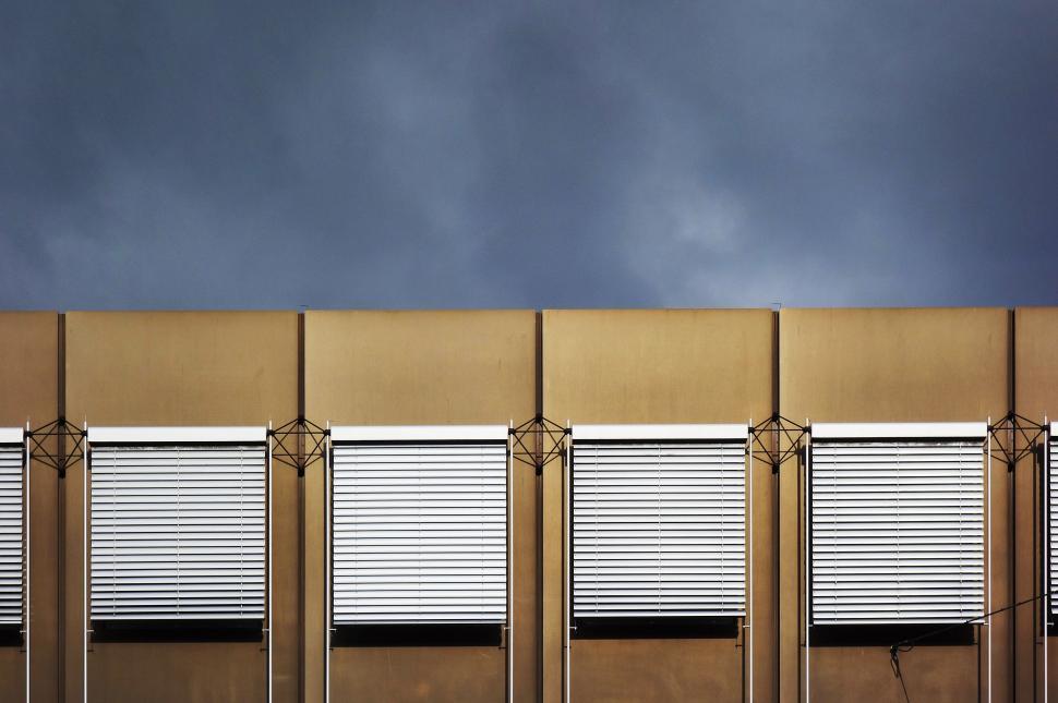 Free Image of Row of Closed Shutters on Side of Building 