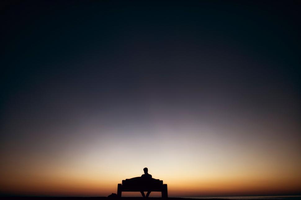 Free Image of Person Sitting on Bench at Sunset 