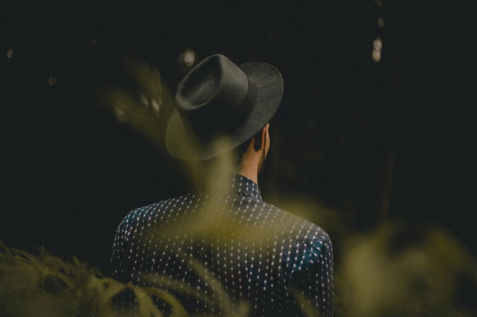 Free Image of Person With a Hat Standing in the Dark 