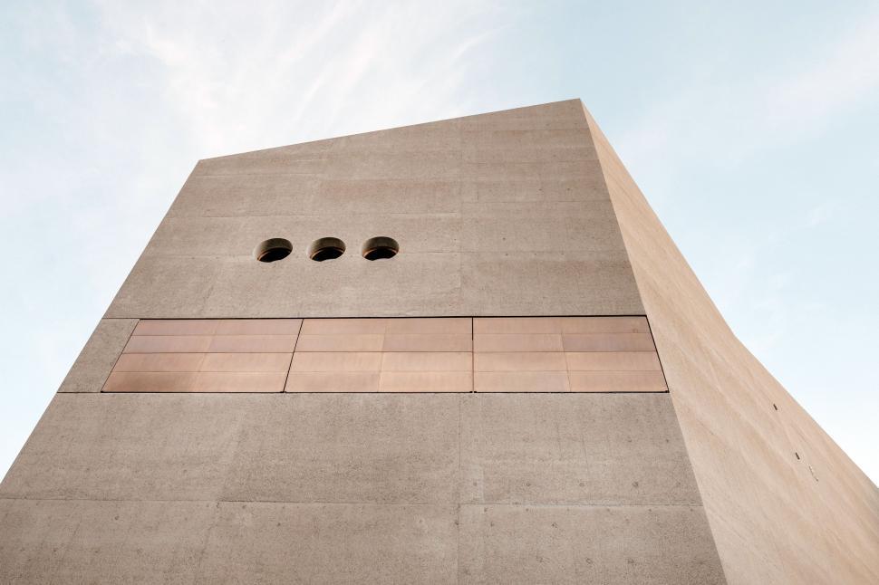 Free Image of Tall Building With Three Holes 