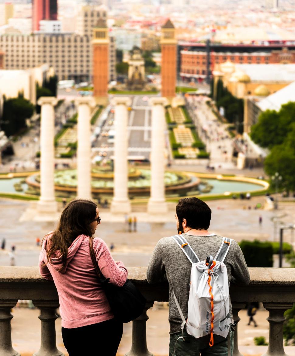 Free Image of Couple Standing on Balcony Overlooking City 