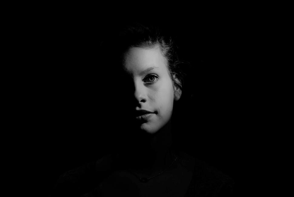 Free Image of Woman Standing in Darkness 