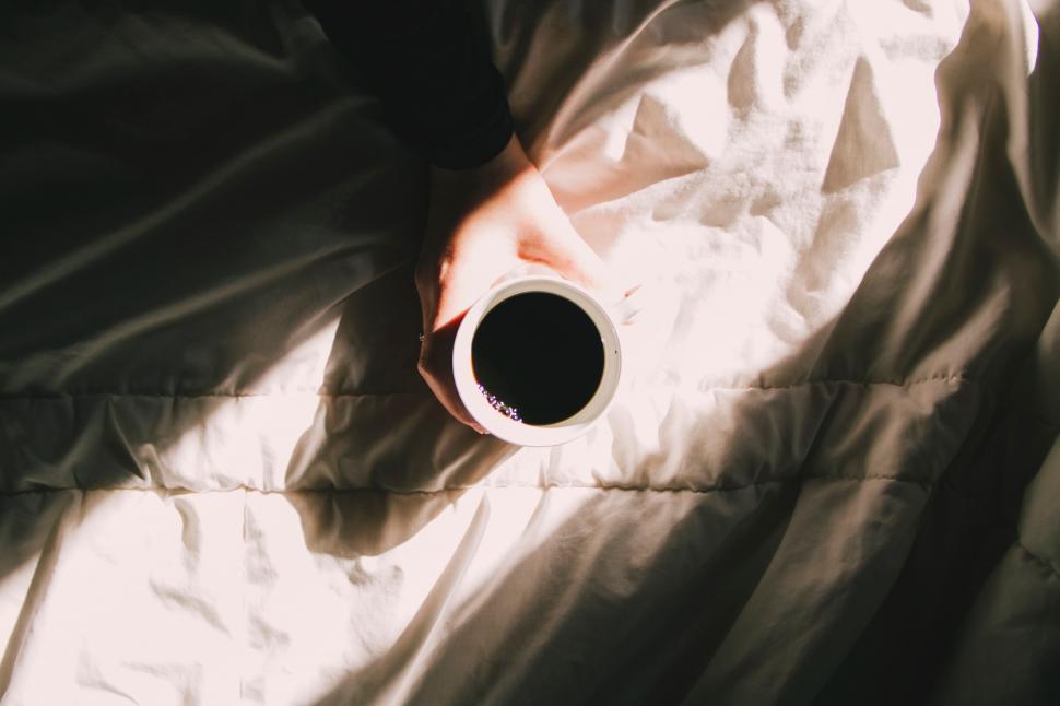 Free Image of Cup Resting on Bed 