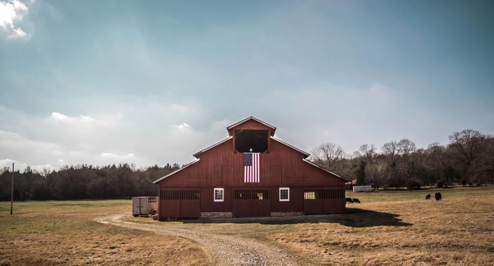Free Image of Red Barn in Field Near Forest 
