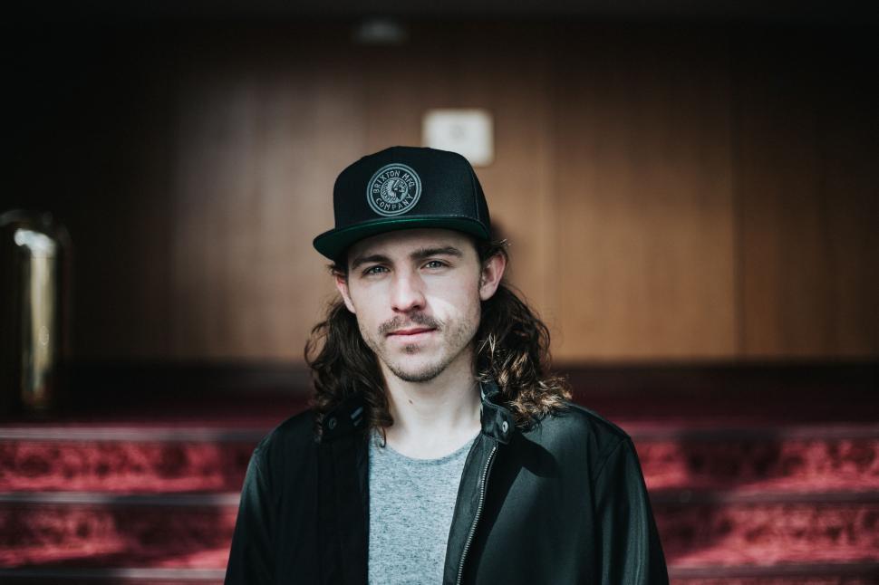 Free Image of Man With Long Hair Wearing Green Hat 