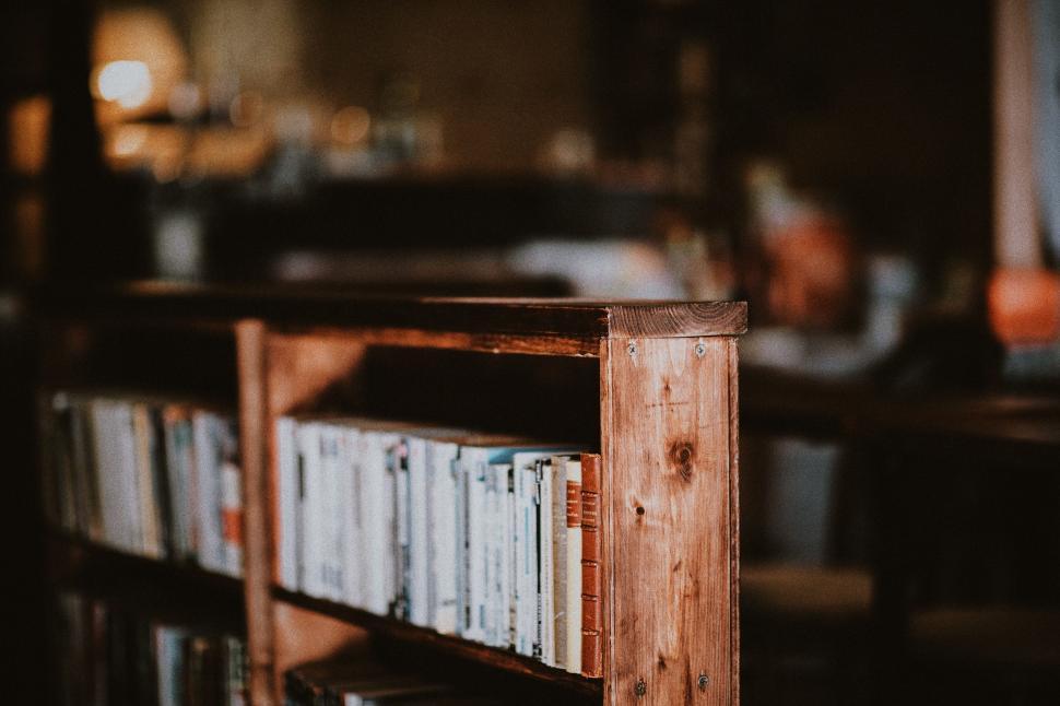 Free Image of A Bookshelf Filled With Many Books in a Room 