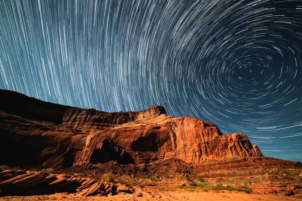 Free Image of Mountain Peak With Star Trail in the Night Sky 