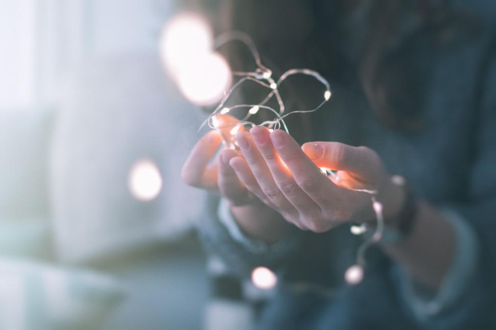 Free Image of Woman Holding a String of Lights 