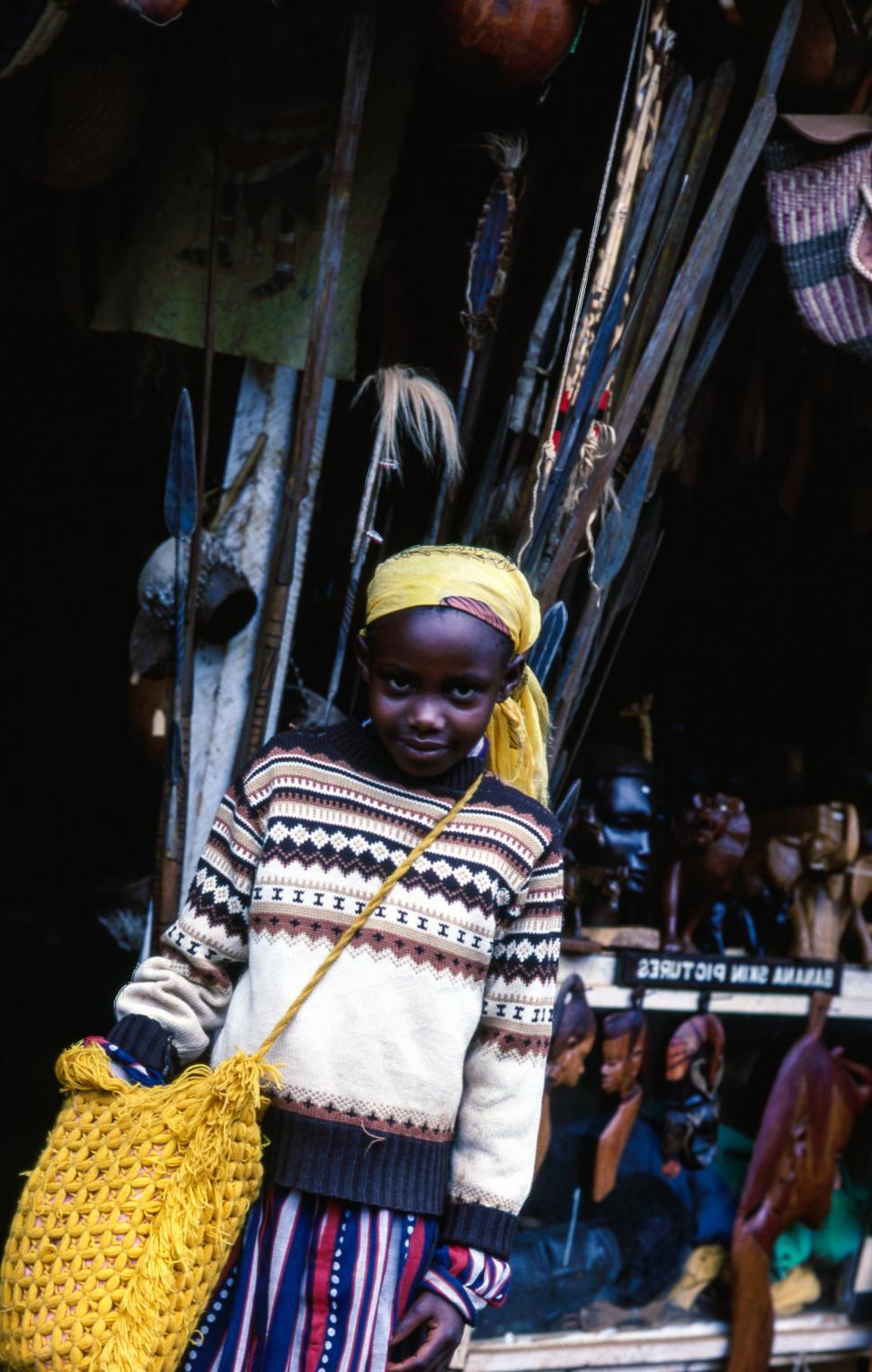 Free Image of Young Girl Carrying Yellow Bag in Market 