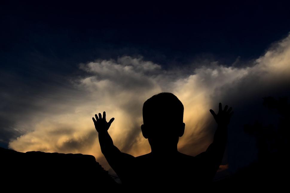 Free Image of Silhouette of Person With Hands Raised 