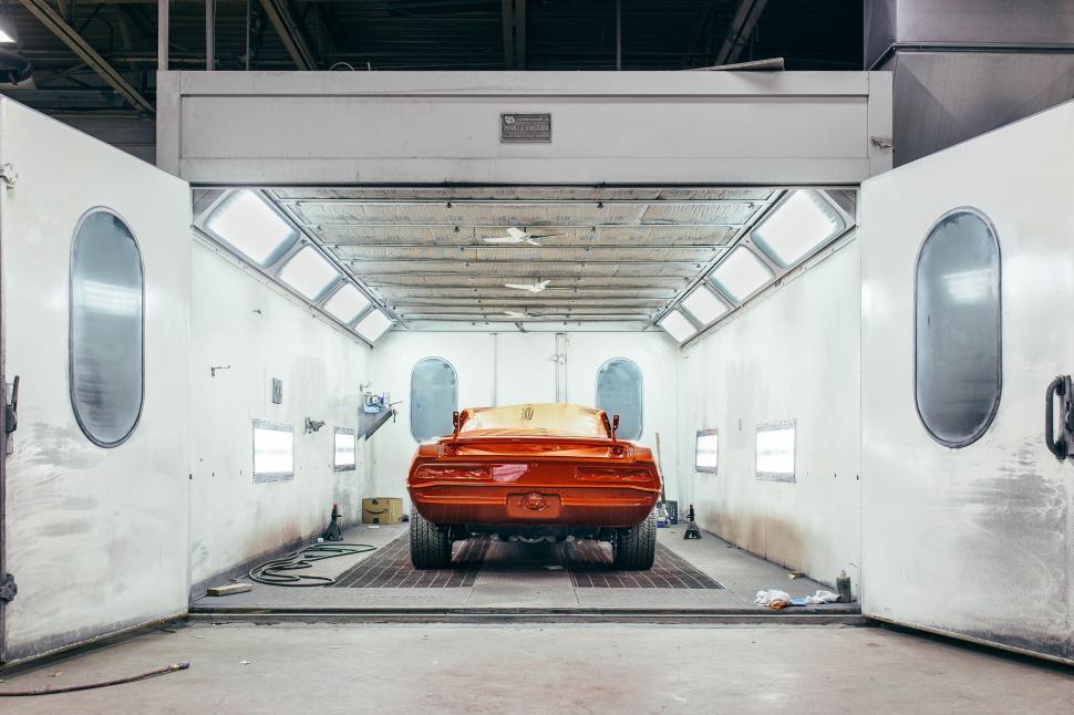 Free Image of Orange Car Parked in Garage 