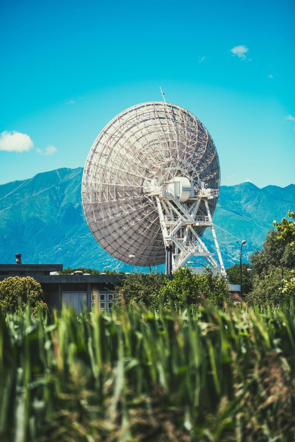 Free Image of Large Satellite Dish on Lush Green Field 