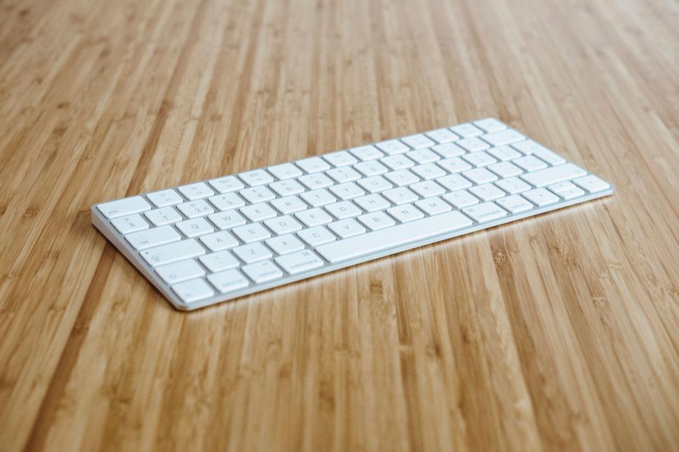 Free Image of White Keyboard on Wooden Table 