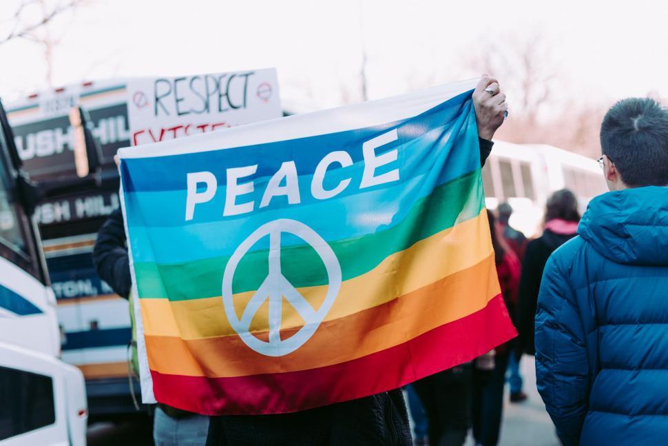 Free Image of Person Holding Peace Sign in Front of Bus 