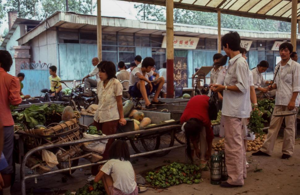 Free Image of Group of People Standing Around a Market 