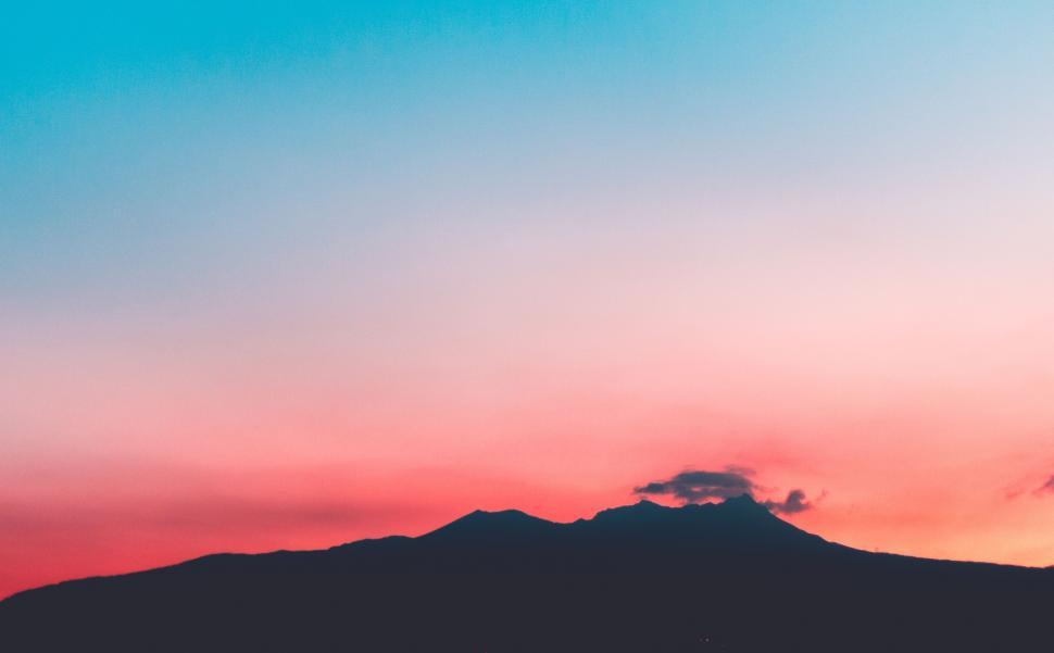 Free Image of Pink and Blue Sky With Background Mountain 