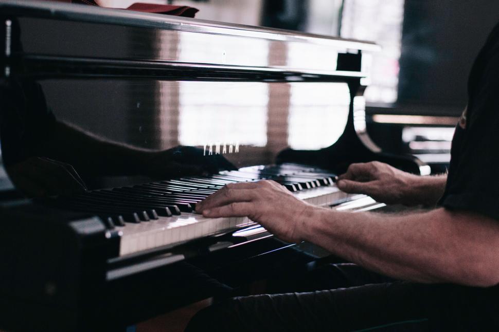 Free Image of Man Playing Piano in Music Room 