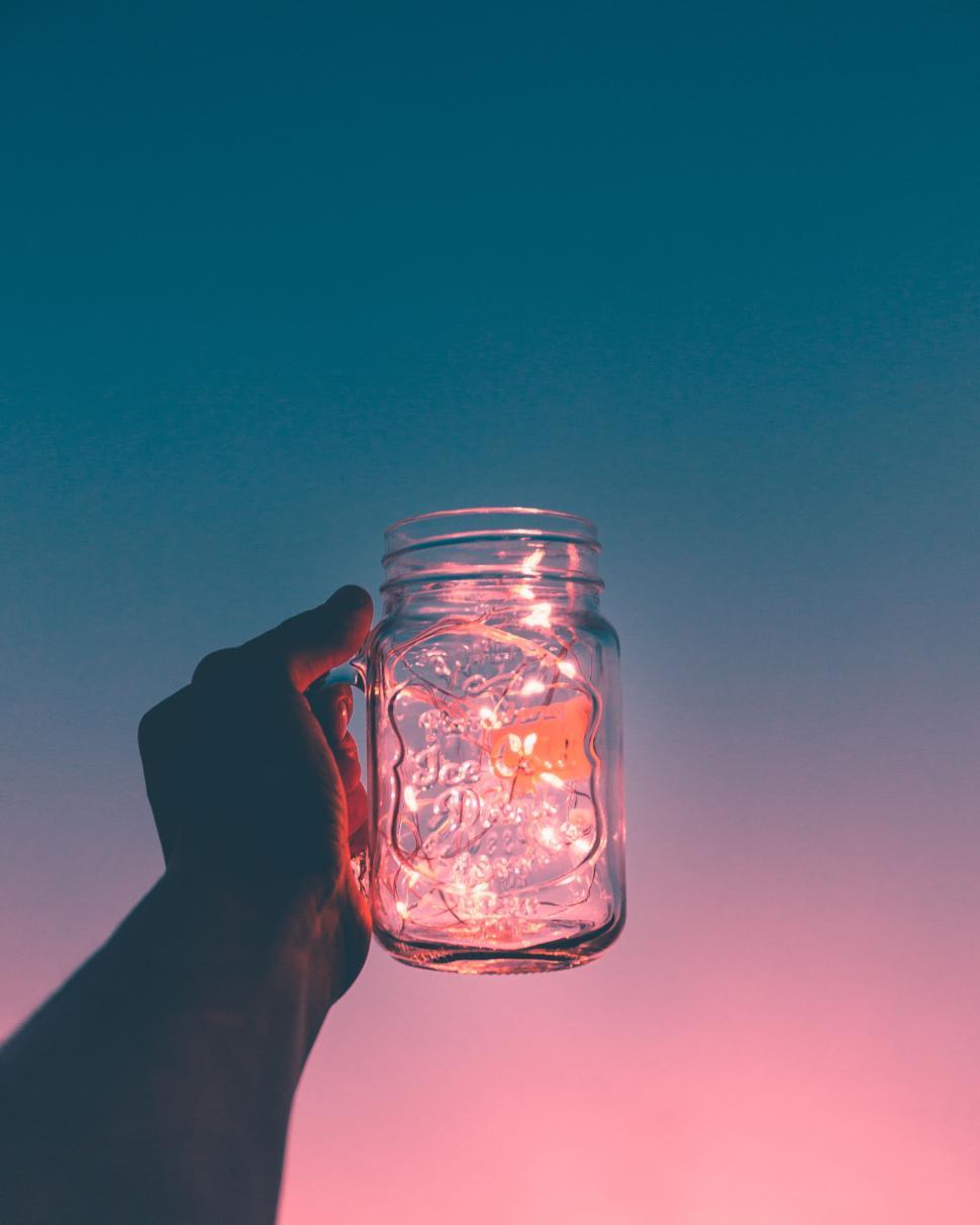 Free Image of Hand Holding Mason Jar Filled With Light Bulbs 
