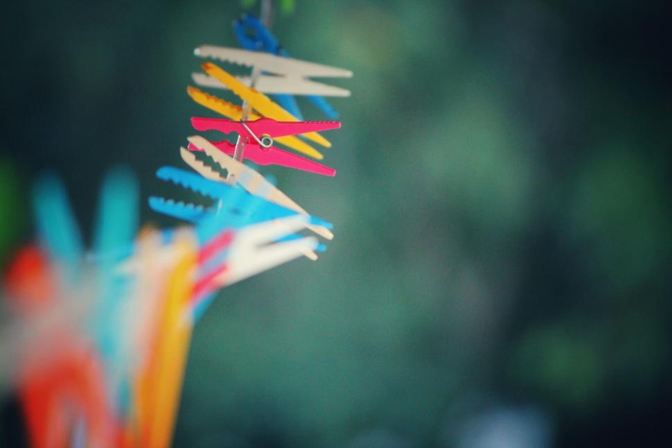 Free Image of Colorful Toothbrushes Hanging From a String 