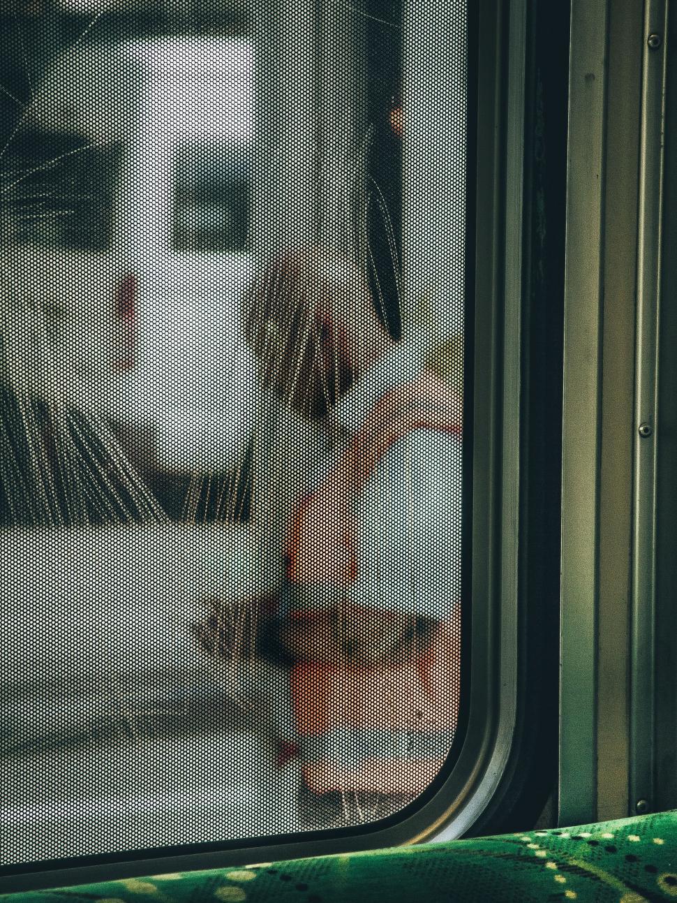 Free Image of Person Looking Out the Window of a Bus 
