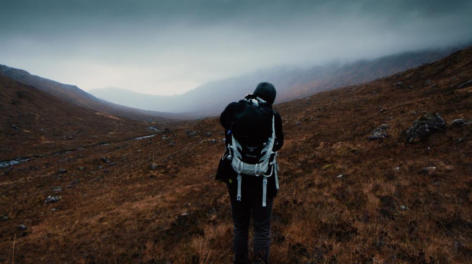 Free Image of Person Hiking Uphill With Backpack 