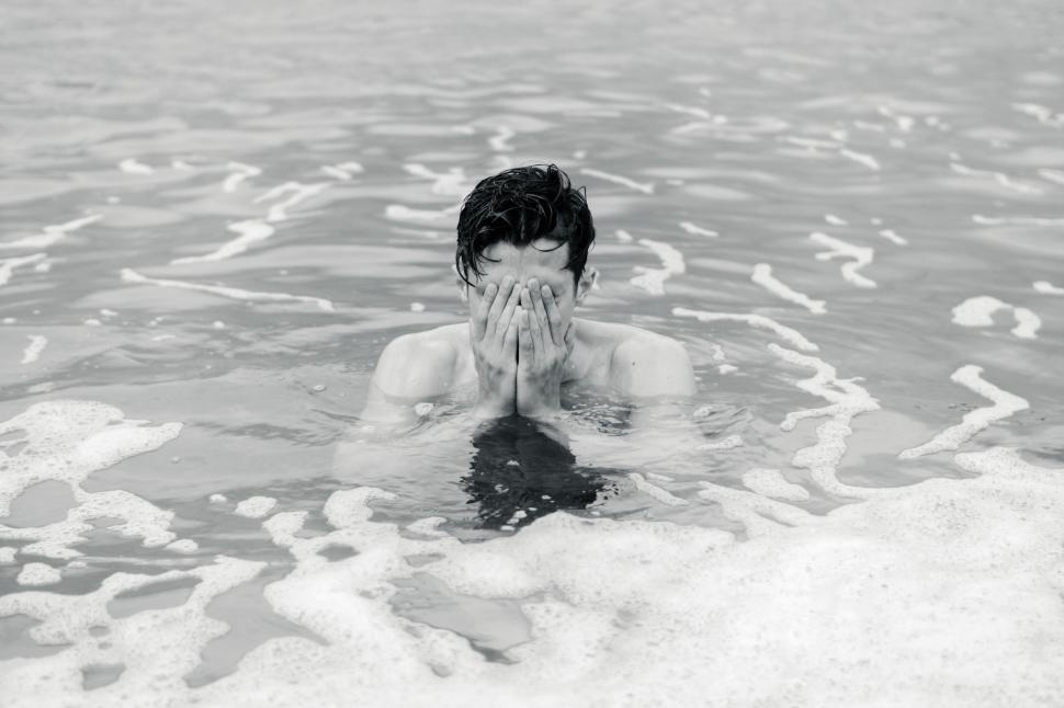 Free Image of Man Covering Face in Water 