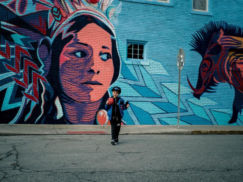 Free Image of Person Standing in Front of Large Mural 