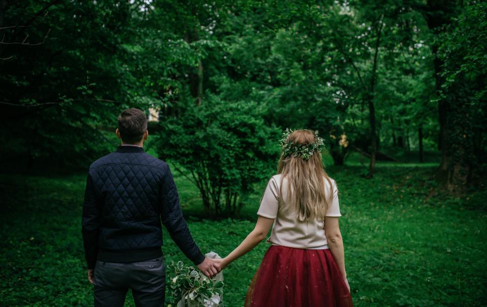 Free Image of Man and Woman Holding Hands in Forest 