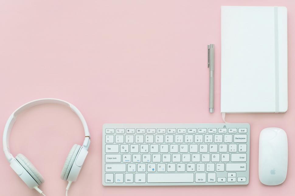 Free Image of Keyboard, Headphones, Notebook on Pink Background 