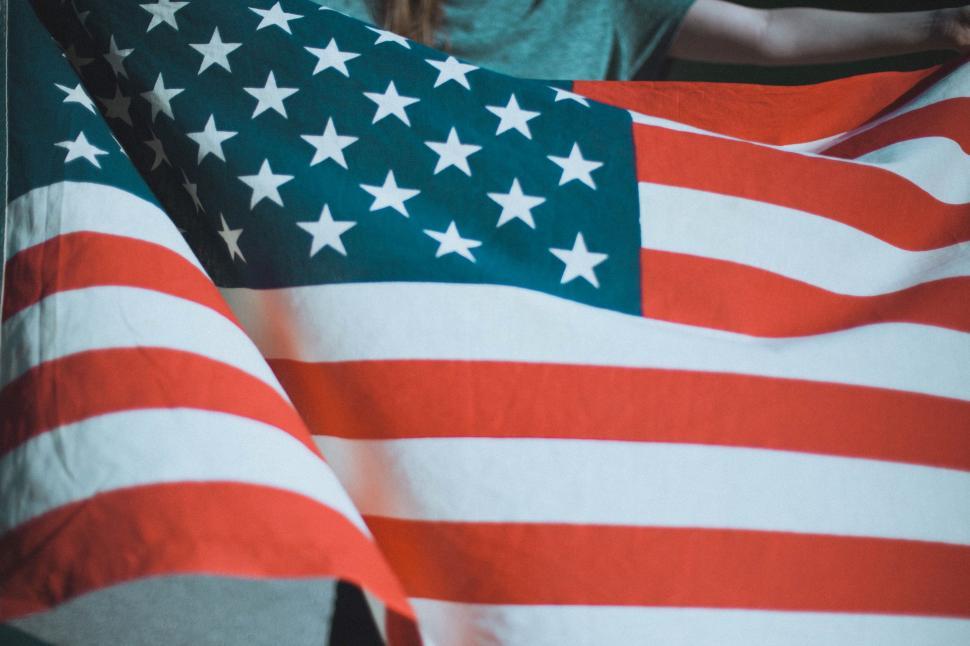 Free Image of Woman Holding Large American Flag 
