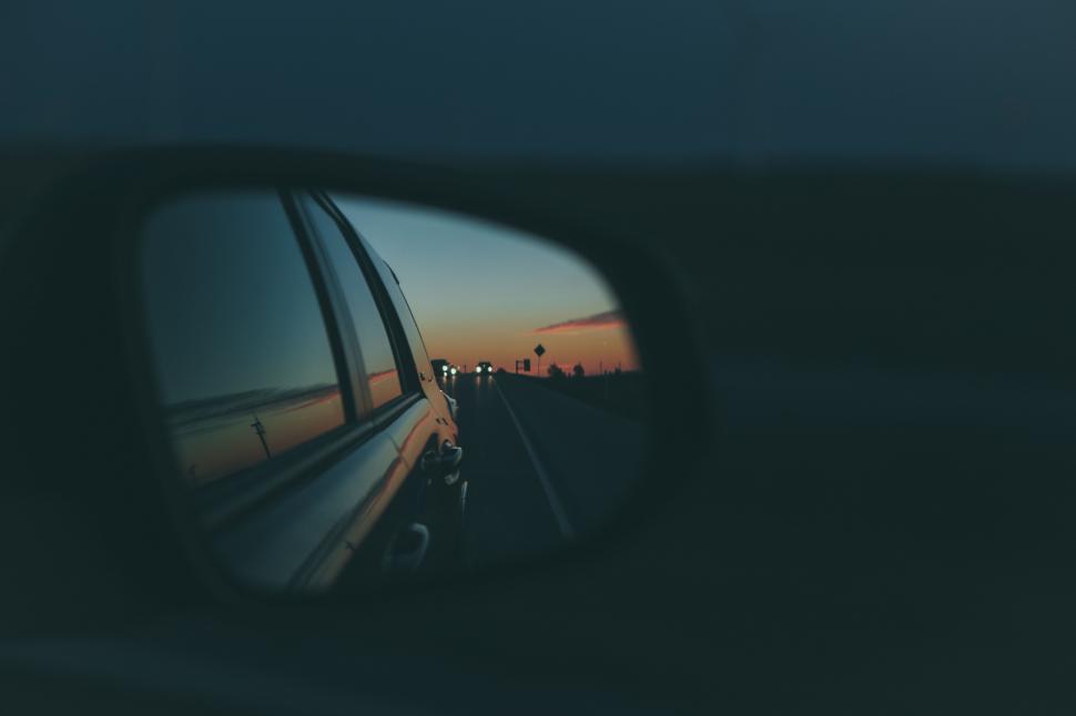 Free Image of Sunset Reflected in Car Rear View Mirror 