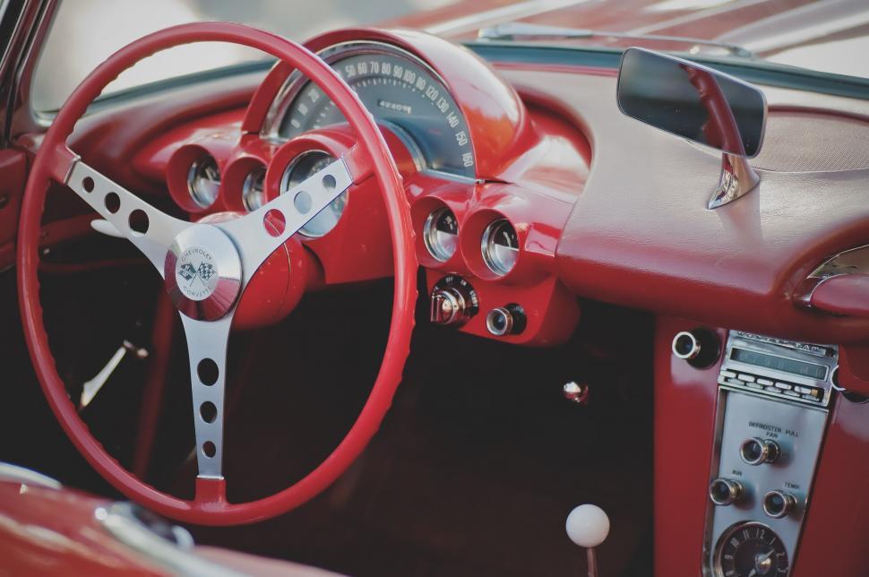 Free Image of Red Car With Steering Wheel and Dashboard 