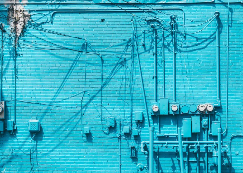 Free Image of Blue Brick Wall With Electrical Wires 