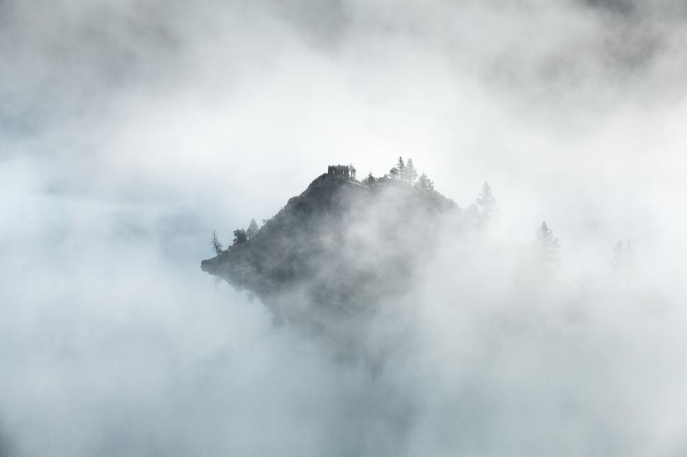 Free Image of Fog-Covered Mountain With Trees 