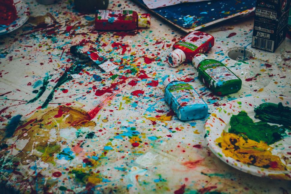 Free Image of Messy Room With Paint and Paintbrushes on Floor 