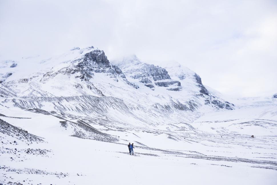 Free Image of Person Standing in Snow in Front of Mountain 