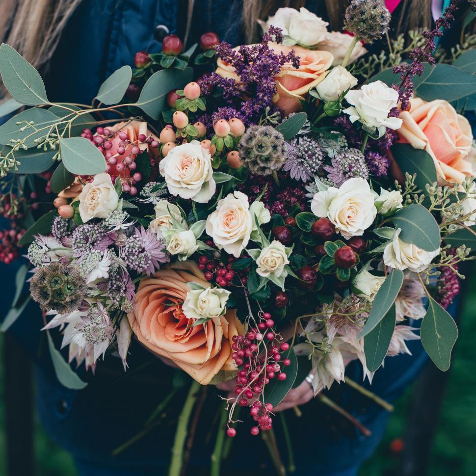 Free Image of Woman Holding a Bouquet of Flowers 