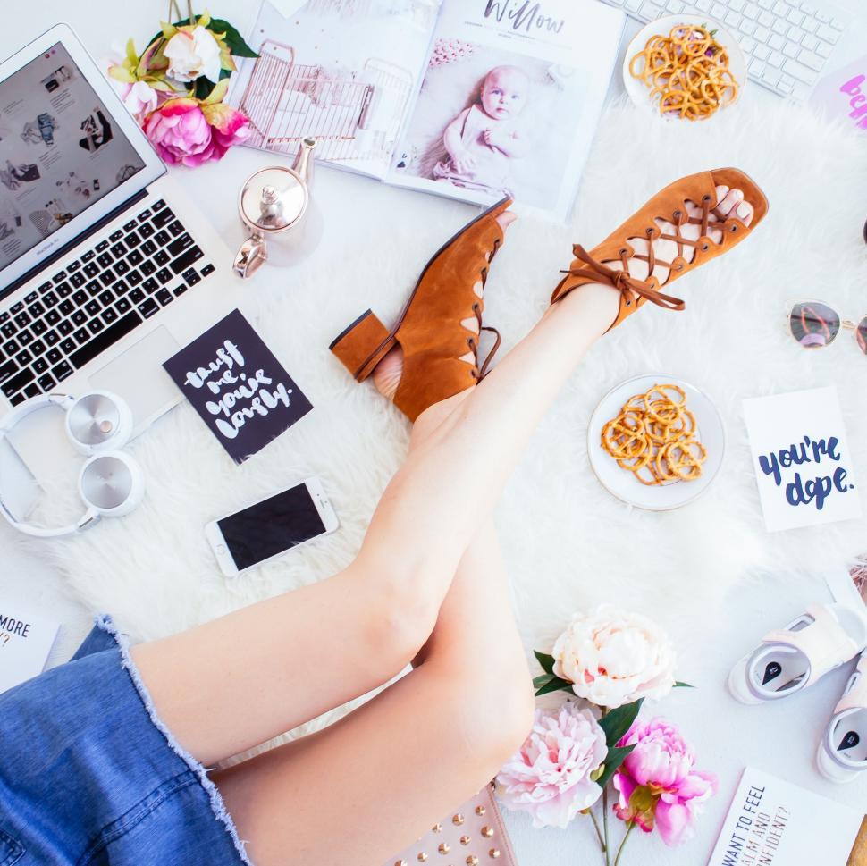 Free Image of Womans Feet on Table With Laptop and Flowers 
