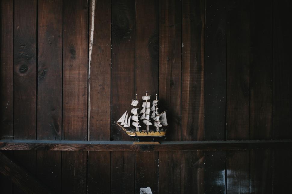 Free Image of Boat Placed on Shelf in Dark Room 