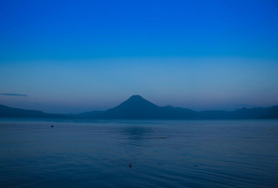 Free Image of Large Body of Water With Distant Mountain 