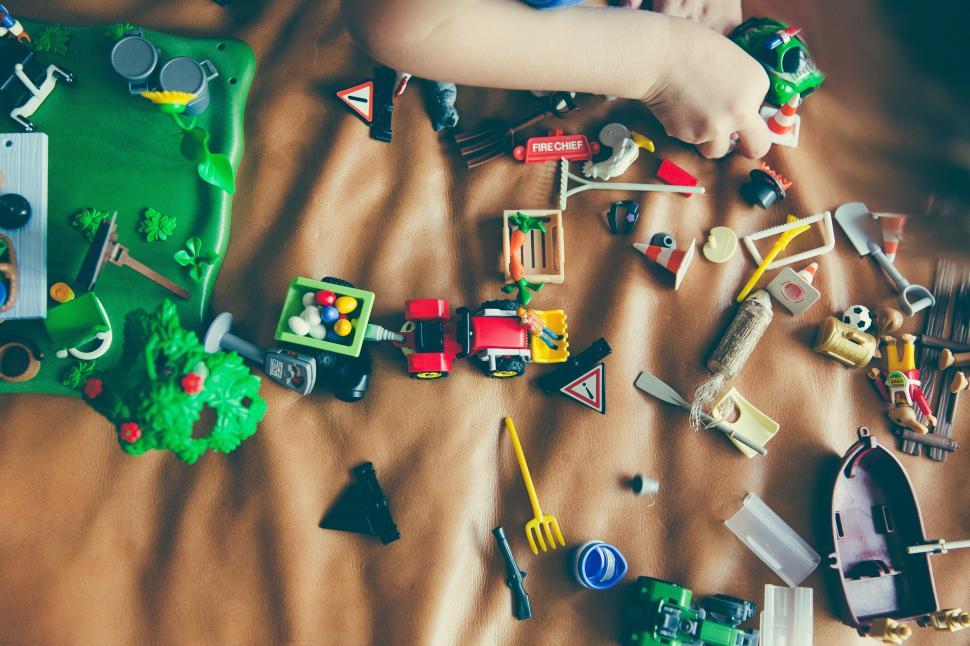 Free Image of Child Playing With Toys on Bed 